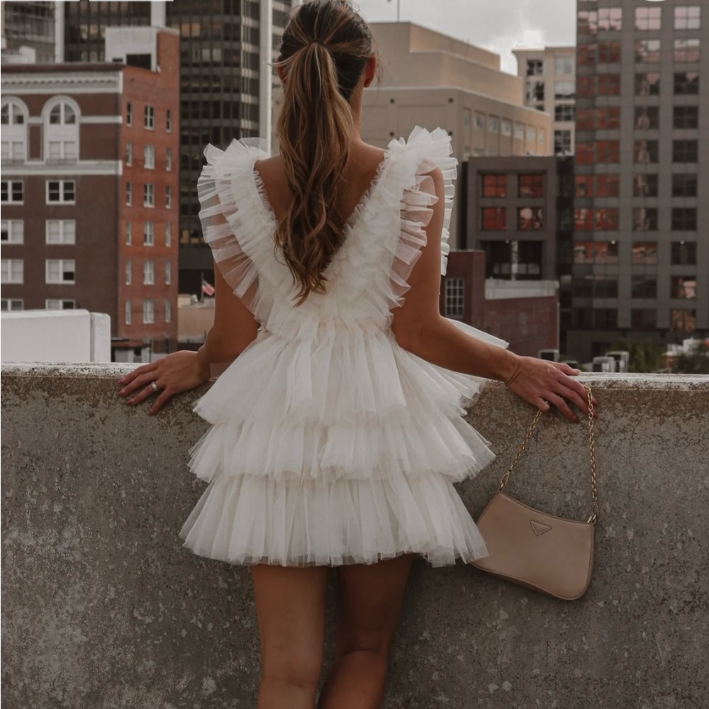 A white dress for any special occasion.It is new with the tag from Lauren Nicole